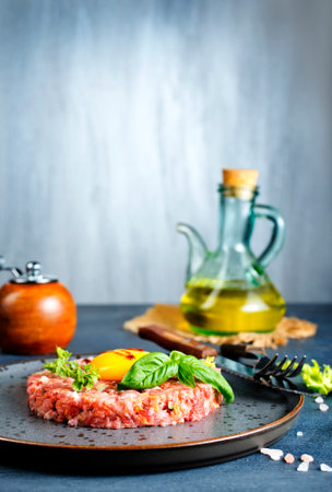 Top view of raw minced meat with liquid egg yolk for preparation of meatballの写真素材