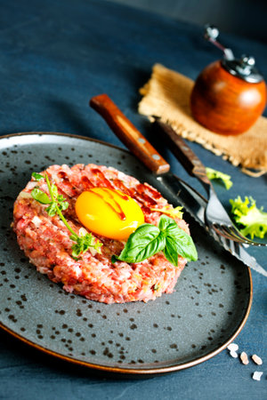 Top view of raw minced meat with liquid egg yolk for preparation of meatballの写真素材