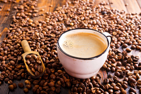 Coffee cup and coffee beans on wooden background. Selective focus.の写真素材