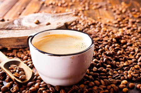 Coffee cup and coffee beans on a wooden background. Selective focus.の写真素材