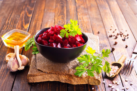 Beetroot salad with parsley in bowl on rustic wooden table. Selective focus.の写真素材