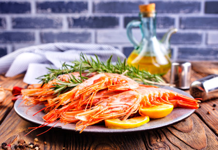 boiled shrimps with fresh lemon and dill on plateの写真素材