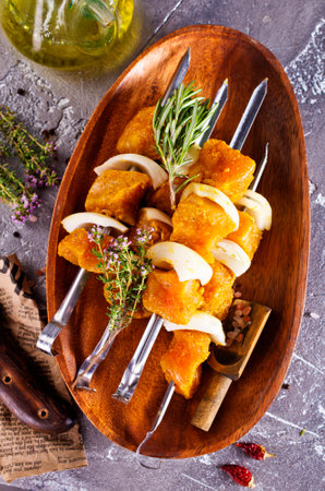 raw kebab with vegetables on wooden plateの写真素材