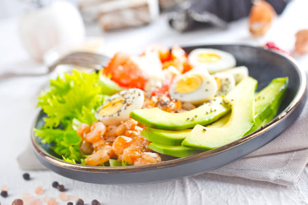 Rice bowl with shrimps and avocado on white tableの写真素材