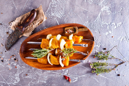 raw kebab with vegetables on wooden plateの写真素材
