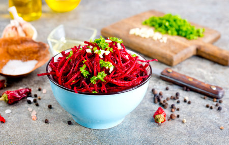 delicious fresh beet salad with greens and spice on gray stone background.の写真素材