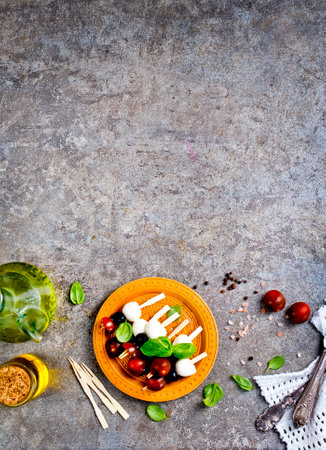 A plate with Italian salad caprese canape, canape with mozzarella and tomatoの写真素材