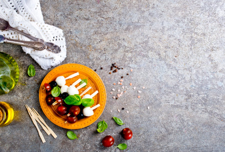 A plate with Italian salad caprese canape, canape with mozzarella and tomatoの写真素材