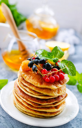 pancakes on white plate and on a tableの写真素材