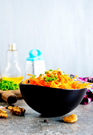 Korean carrot spicy salad in the bowl on a tableの写真素材