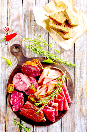 Slices of delicious spanish sausage salam, smoked meat, sausages. Healthy food concept.の写真素材