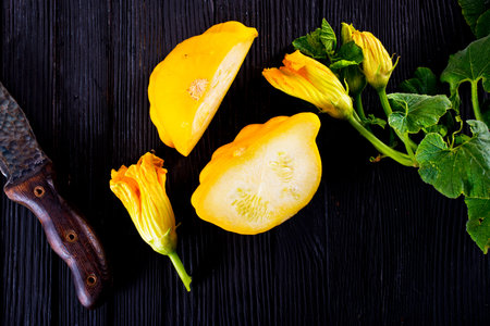 Yellow patisons on wooden table, top viewの写真素材