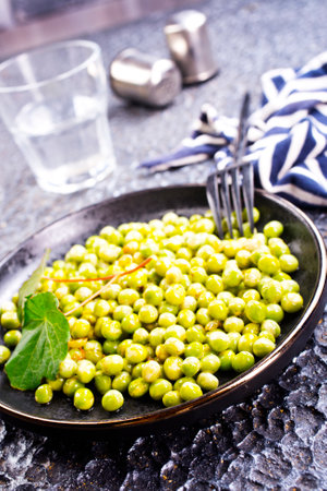 Fresh green pea beans on plateの写真素材