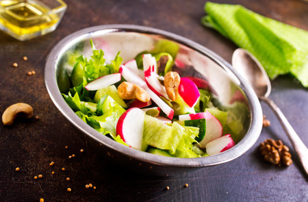 A salad of fresh organic radish, cucumber with dill and green onionsの写真素材
