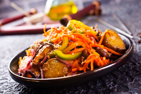 Summer Vegetable stew of zucchini, potatoes, peppers, onions, tomatoes and eggplant close-up in a bowl on the table.の写真素材