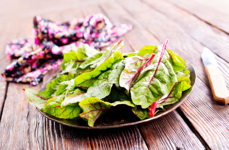 Fresh salad leaves. Raw green leaf vegetables. Mangold leaves on plateの写真素材