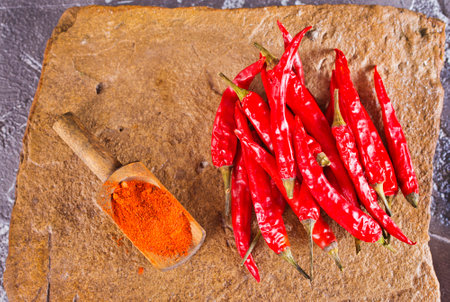 Red hot chilli pepper. Fresh thick and big red chilly on stone backgroundの写真素材