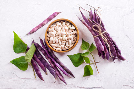 Uncooked dried white haricot beans in bowl
