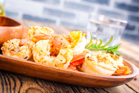 Fried shrimps with garlic, lime on plateの写真素材