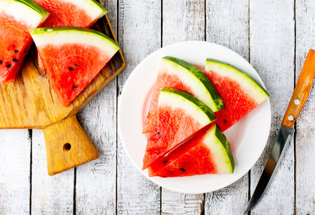 Pieces of juicy, ripe watermelon on white plateの写真素材