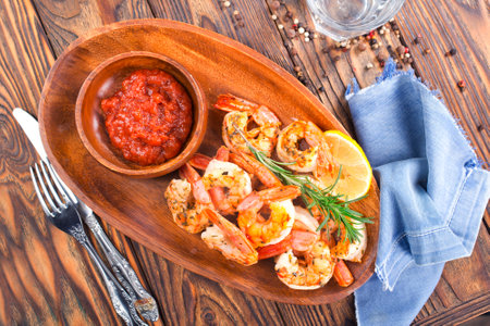 Fried shrimps with garlic, lime on plateの写真素材