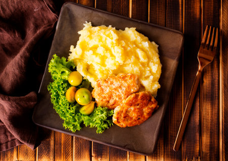 Chicken cutlets with mashed potatoes, meat cutlets with mashed potatoes and tomatoes on a plate onの写真素材