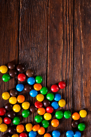 color candy from chocolate on wooden backgrondの写真素材