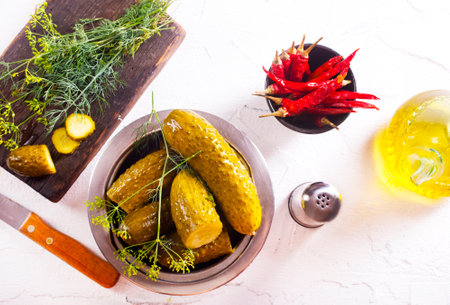pickled cucumber in metal bowl, cucumber in bowl on a tableの写真素材