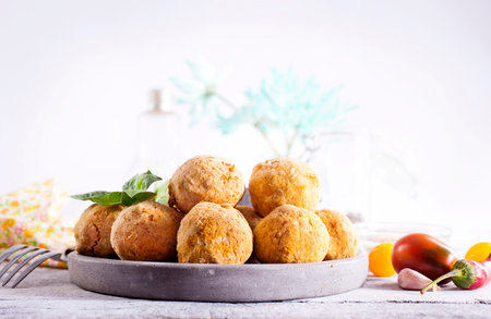 fried organic falafel balls on white wooden table, vegan food