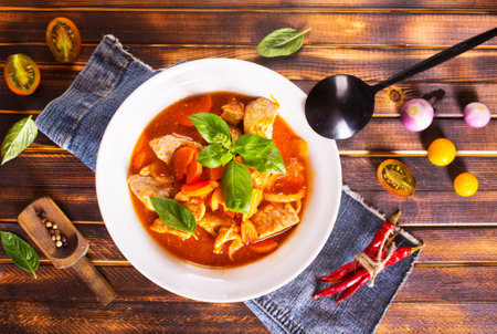 baked meat with tomato sauce in bowl on a tableの写真素材