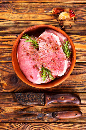 raw meat with spice on plate on a tableの写真素材