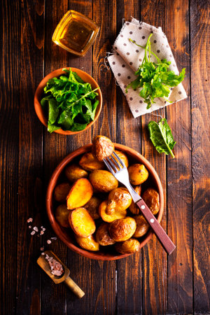 baked potato wedges with sauce on wooden background, top viewの写真素材