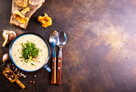 cream soup with dried mushrooms on stone backgroundの写真素材