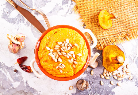 Pumpkin cream soup with wild mushrooms in bowlの写真素材