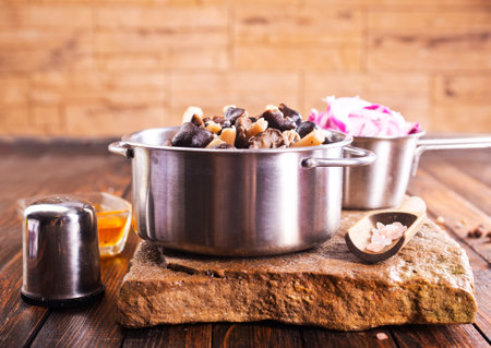 mushrooms in metal bowl with spice and onionの写真素材