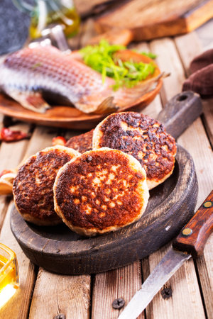 Cooked fried fish cutlets, on a light wooden table.の写真素材