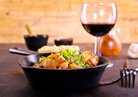 Fried meat with herb and spices. Portion of fried meat and red wineの写真素材