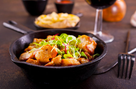 Fried meat with herb and spices. Portion of fried meat and red wineの写真素材