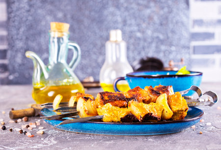 Chicken skewers with spice and salt on a plateの写真素材
