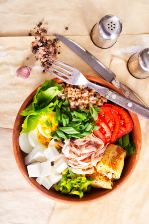 Delicious healthy breakfasts, buckwheat with boiled egg and meat and cheese on plateの写真素材