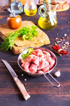 raw meat in metal bowl, meat and herb and spices for cookingの写真素材