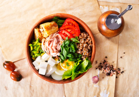 Delicious healthy breakfasts, buckwheat with boiled egg and meat and cheese on plateの写真素材