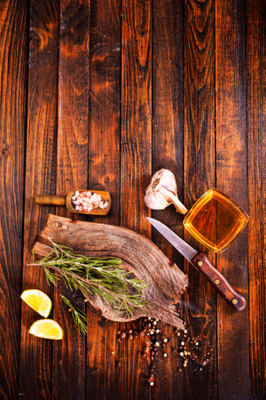 Rosemary sprig on a wooden kitchen table. Top view with copy space.の写真素材