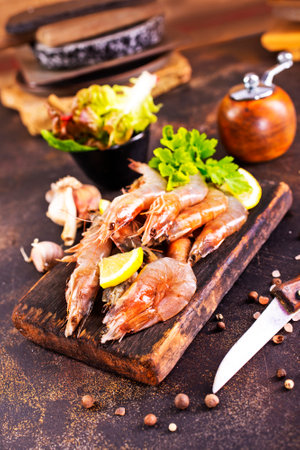 Shrimps Prawns skewers with herbs, garlic and lemon on a tableの写真素材