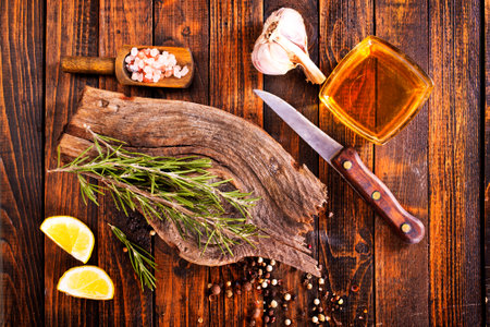 Rosemary sprig on a wooden kitchen table. Top view with copy space.の写真素材