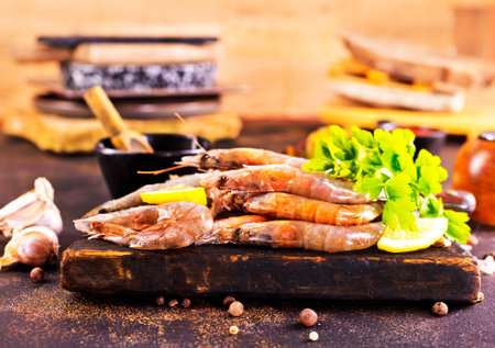 Shrimps Prawns skewers with herbs, garlic and lemon on a tableの写真素材