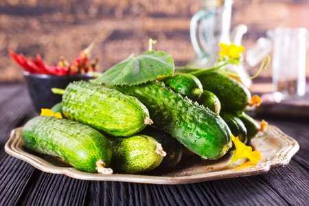 Heap of fresh cucumbers on metal plateの写真素材