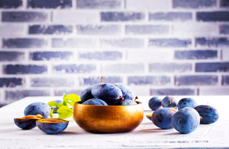 fresh ripe plums on a tableの写真素材