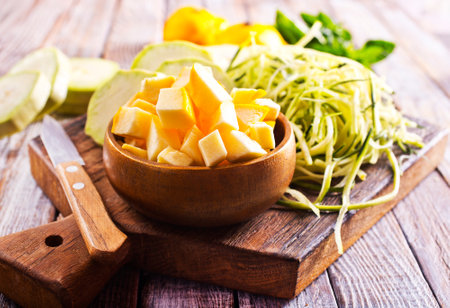 raw zucchini and patisons on board on a table, fresh vegetablesの写真素材