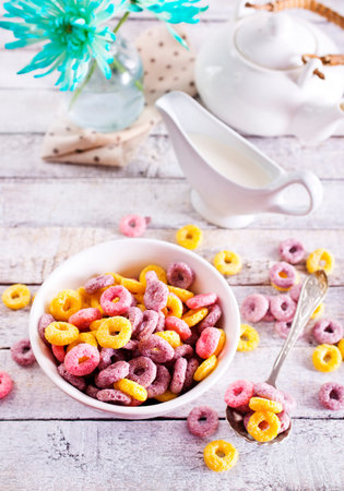Concept of breakfast food, colorful corn flakes, top view
